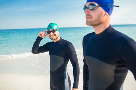 Swimmers getting ready at the beach on a sunny dayの写真素材