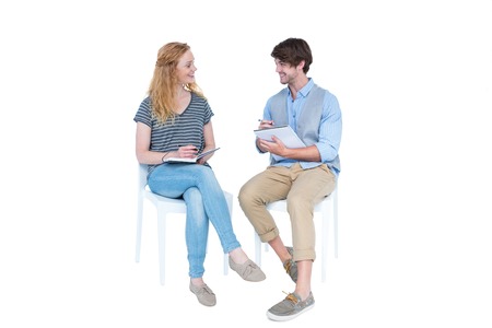 Happy couple speaking and taking notes on white backgroundの写真素材