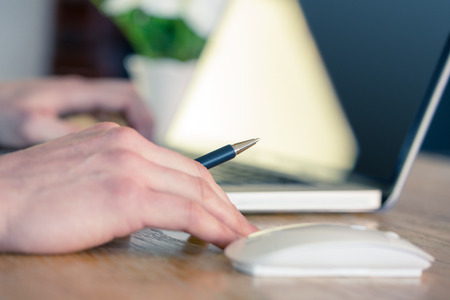 Close up of businessman working at desk in his officeの写真素材