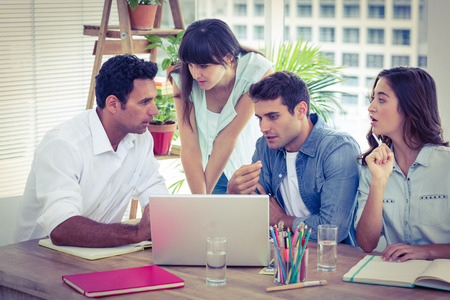 Group of young colleagues having a meeting at office