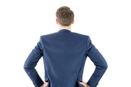 Wear view of businessman with hands on hip on white backgroundの写真素材