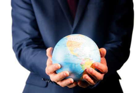 Hand of businessman holding terrestrial globe on white backgroundの写真素材