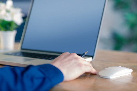 Close up of businessman working at desk in his office