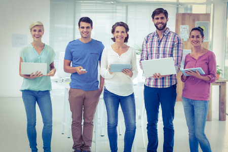 Young creative business people with laptop and digital tablet in the office