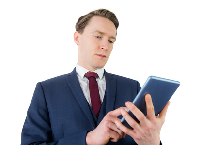 Businessman looking at his smartphone on white backgroundの写真素材