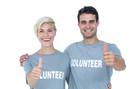 Cute couple of young volunteers gesturing thumbs up