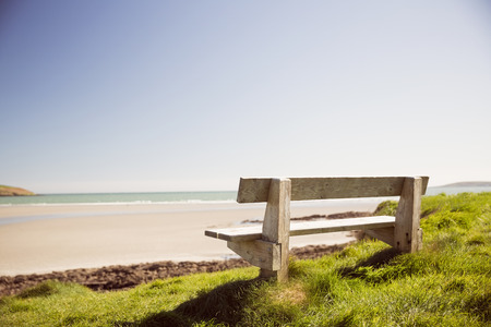 Stone bench near the sea on a sunny dayの写真素材