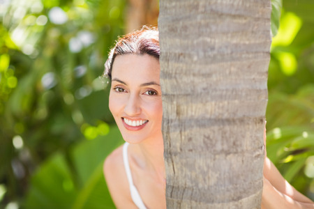 Portrait of a woman in a meditation position against a white backgroundの写真素材