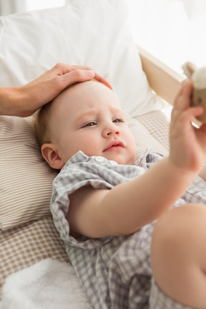 Very beautiful cute baby boy at home in bedroomの写真素材