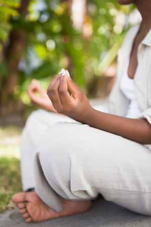 A young woman doing yoga over white backgroungの写真素材