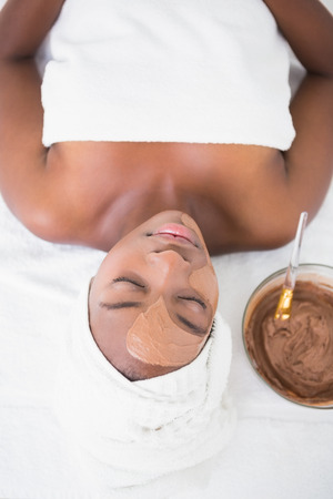 Pretty woman getting a chocolate facial treatment at the health spaの写真素材