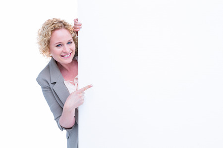 Woman pointing around blank sign on white backgroundの写真素材
