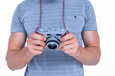 Close up view of man holding photo camera on white backgroundの写真素材