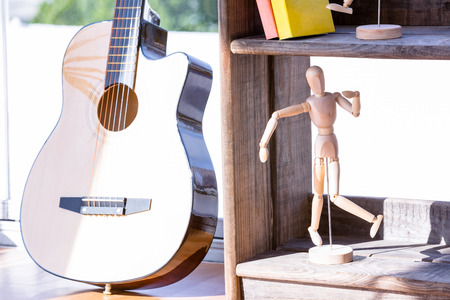 Close up of mannequin and guitar in creative business officeの写真素材