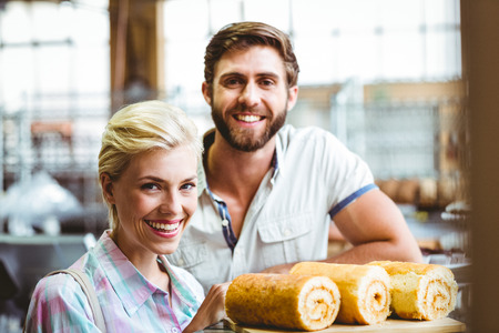 Portrait of cute couple on a date looking at the camera at the bakeryの写真素材