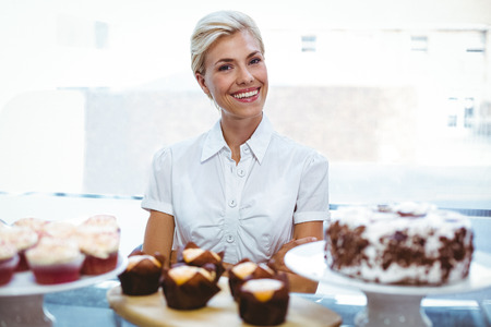 Selfassured female waitress in the bakeryの写真素材