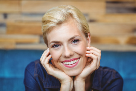 Portrait of a pretty blonde smiling at the cameraの写真素材