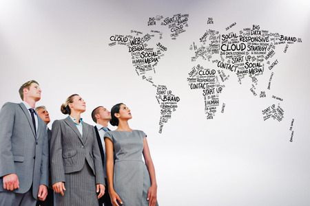 Business team looking up against grey background