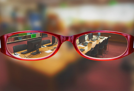 Glasses against computer desks in the library