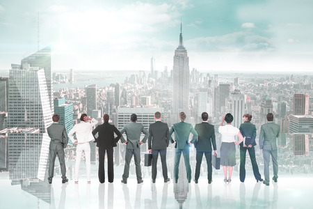 Business team against room with large window looking on cityの写真素材