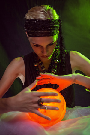 Fortune teller forecasting the future on black backgroundの写真素材