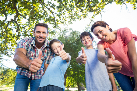 Happy family in the park together on a sunny dayの写真素材