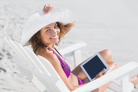 pretty brunette in swimsuit at the beachの写真素材