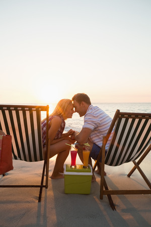 happy couple smiling at the beachの写真素材