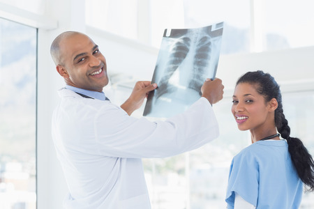 Doctors analyzing together xray in medical office