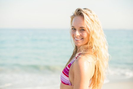 beautiful blonde woman on a sunny day at the beachの写真素材