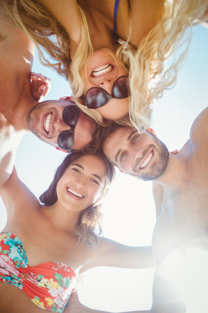 group of friends in swimsuits taking a selfie at the beachの写真素材