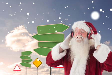 Santa Claus enjoys some music against group of empty signpostsの写真素材