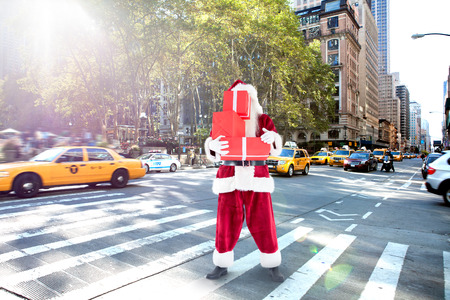 Santa covers his face with presents against new york streetの写真素材