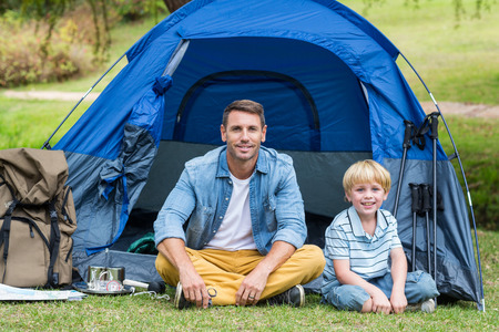 Father and son having fun in the park on a sunny dayの写真素材