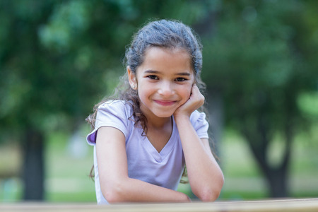 Little girl smiling at the camera on a sunny dayの写真素材