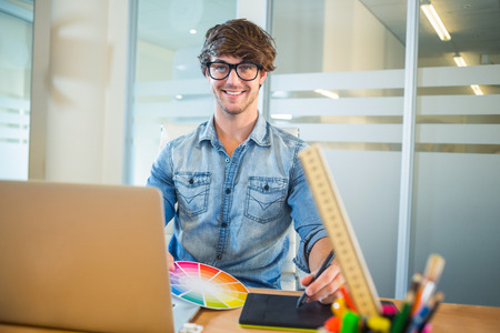 Designer working with colour wheel and digitizer in the officeの写真素材