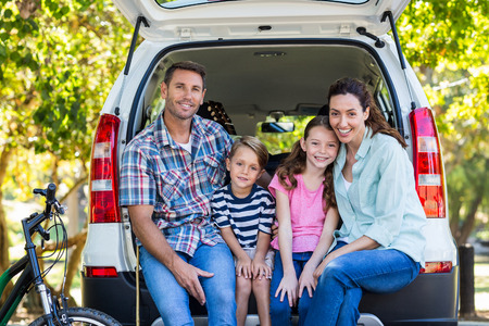 Happy family getting ready for road trip on a sunny dayの写真素材