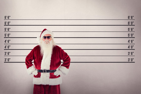 Santa Claus wears black sunglasses  against mug shot backgroundの写真素材