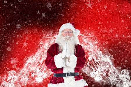 Father Christmas doing some yoga against blurred snowflake designの写真素材