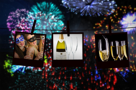 Attractive friends with masks on holding champagne glasses against full glasses of champagne and one...