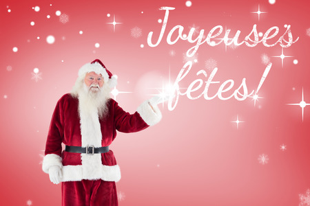 Santa shows something to camera against red vignetteの写真素材