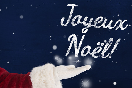 Santa Claus shows open hand against navy blueの写真素材