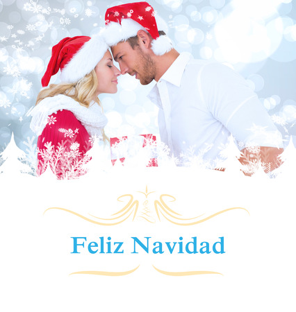 young festive couple against Christmas greeting cardの写真素材