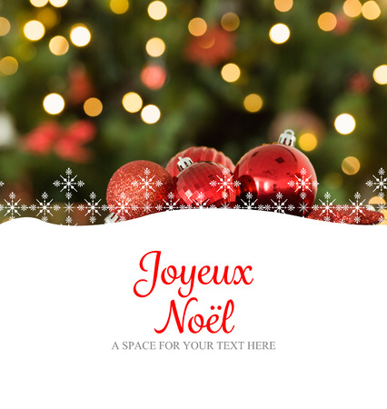 Joyeux noel against focus on red christmas baublesの写真素材