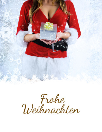 sexy santa girl holding gift against christmas greeting in germanの写真素材