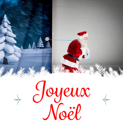 Composite image of santa claus pulling rope against Christmas greeting cardの写真素材