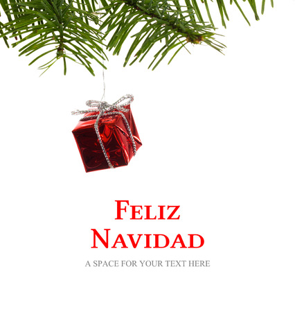 Feliz navidad against red christmas decoration hanging from branchの写真素材