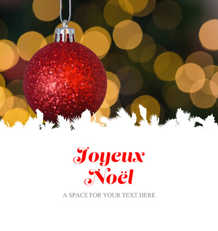 Joyeux noel against red christmas ball decoration hangingの写真素材