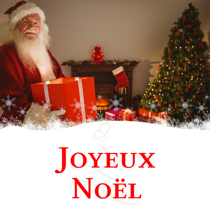 Happy santa delivering presents at christmas eve against tree spiralの写真素材