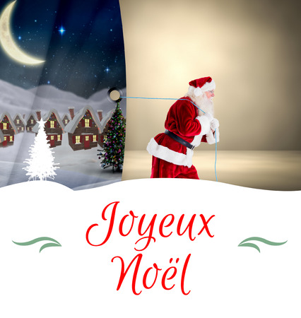 Composite image of santa claus pulling rope against Christmas greeting cardの写真素材